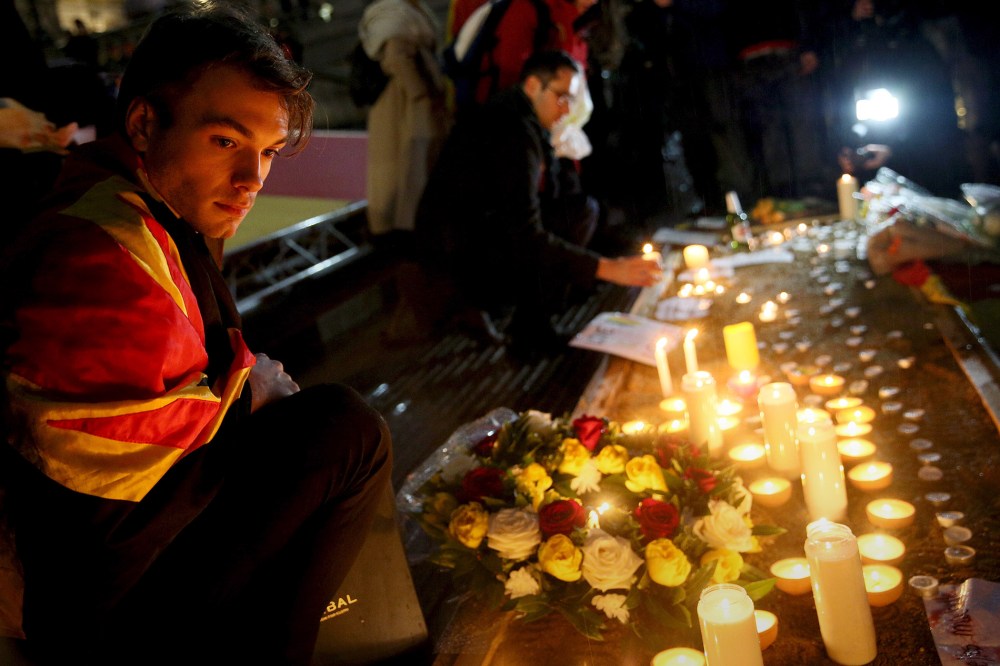 A man looks at candles during a vigil for the victims of the Brussels bomb attacks, at Trafalgar Square in London, Britain, March 24, 2016. (Photo by Neil Hall/Reuters)