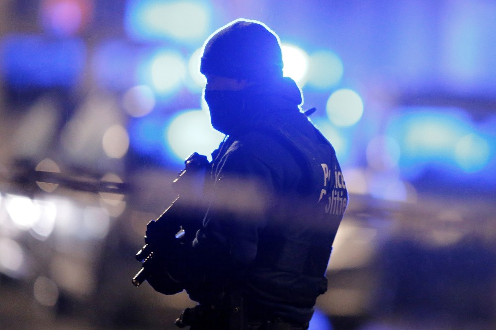A masked Belgian police officer takes part in police operations in Schaerbeek following Tuesday's bomb attacks in Brussels, Belgium, March 25, 2016. (Photo by Vincent Kessler/Reuters)