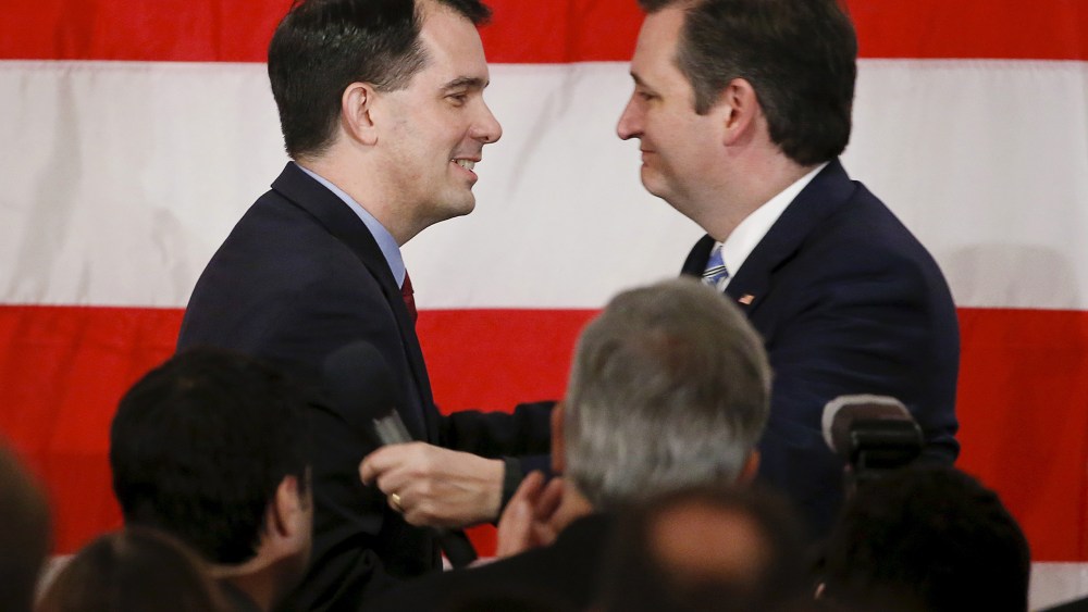 Wisconsin Governor Scott Walker greets on stage presidential candidate Ted Cruz during Milwaukee County GOP's 'Wisconsin Decides 2016' presidential candidate event at the American Serb Banquet Hall, April 1, 2016. (Photo by Kamil Krzaczynski/Reuters)