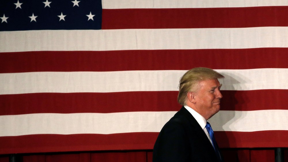U.S. Republican presidential candidate Donald walks to the stage past an American flag at a fundraising event where he appeared with New Jersey Governor Chris Christie in Lawrenceville, N.J., May 19, 2016. (Photo by Mike Segar/Reuters)