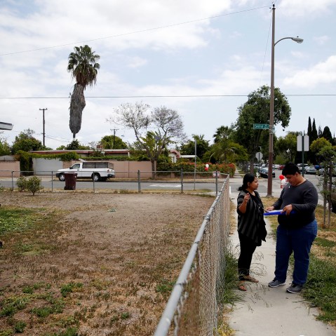 America Najera, 32, and Juan Munoz, 18, of the Democratic Party of Orange County check a voter registration list as they canvass a neighborhood ahead of the California Primary election, Santa Ana, Calif., May 15, 2016. (Photo by Patrick T. Fallon/Reuters)
