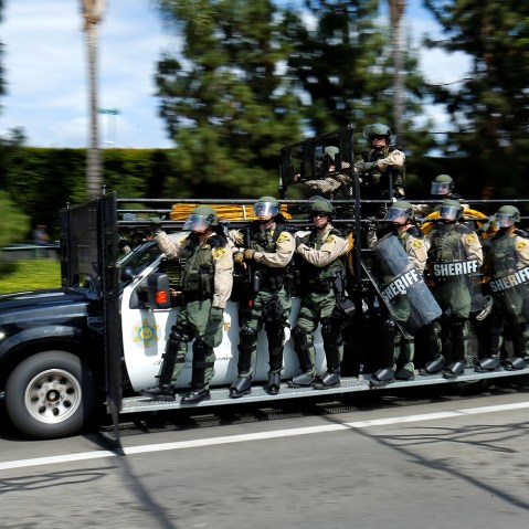 Los Angeles County Sheriffs in riot gear chase demonstrators near Donald Trump's campaign rally in Anaheim, Calif., May 25, 2016. (Photo by Mike Blake/AP)