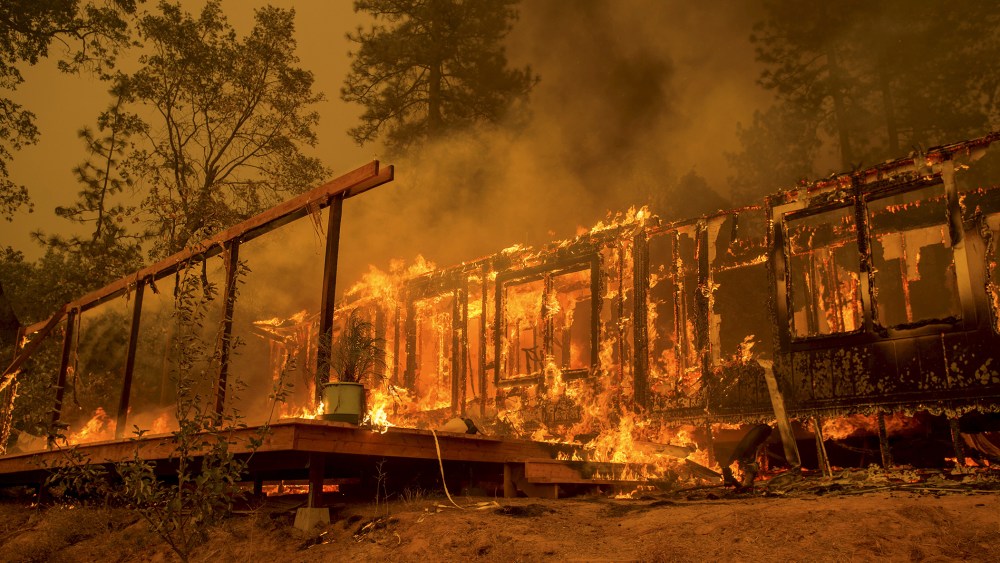 A home burns as the Butte Fire rages near Mountain Ranch, Calif., Sept. 11, 2015. (Photo by Noah Berger/Reuters)