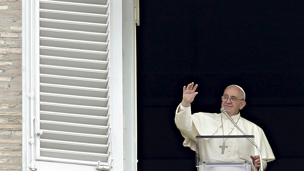 Pope Francis waves the faithful during his Sunday Angelus prayer in Saint Peter's square at the Vatican, Sept. 13, 2015. (Photo by Giampiero Sposito/Reuters)
