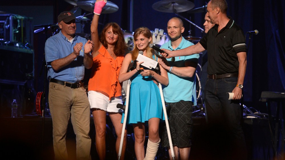 Boston Bombing survivor Victoria McGrath appears with the first responders who rescued her, including Alicia Shambo, during the Boston Strong benefit concert at the Boston TD Garden in Boston, May 30, 2013. (Photo by Gretchen Ertl/Reuters)