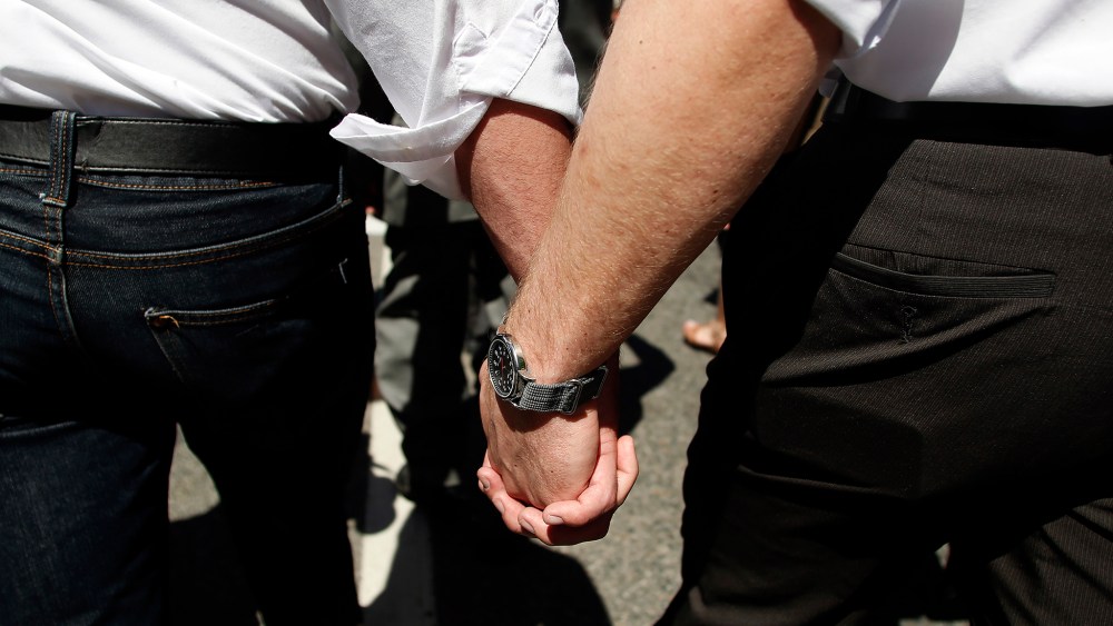 Mormon couple hold hands as they march in a gay pride parade in Salt Lake City, Utah