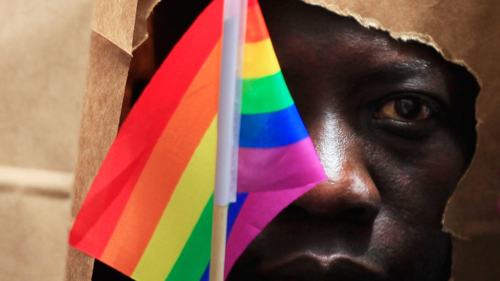 An asylum seeker from Uganda covers his face with a paper bag in order to protect his identity as he marches with the LGBT Asylum Support Task Force during the Gay Pride Parade in Boston, Mass. on June 8, 2013.
