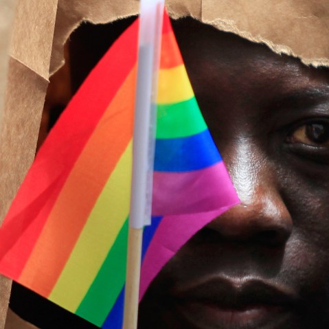 An asylum seeker from Uganda covers his face with a paper bag in order to protect his identity as he marches with the LGBT Asylum Support Task Force during the Gay Pride Parade in Boston, Mass., June 8, 2013. (Photo by Jessica Rinaldi/Reuters)