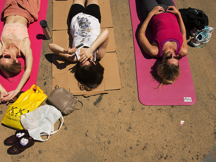 People take part in a group yoga practice on the morning of the summer solstice in New York's Times Square, June 21, 2013. (Photo by Lucas Jackson/Reuters)