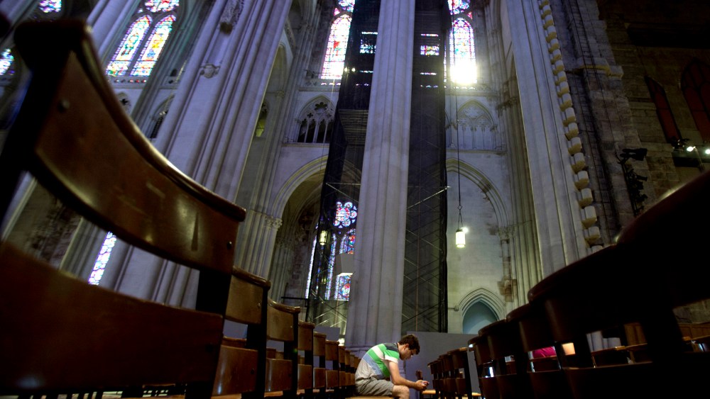 A man sits in the pews of Cathedral of St. John the Divine in New York, June 25, 2013.