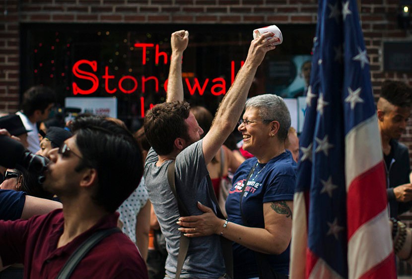 People embrace and cheer as they join a crowd celebrating the U.S. Supreme Court ruling against the Defense of Marriage Act outside the Stonewall Inn in New York June 26, 2013. (Photo by Lucas Jackson/Reuters)
