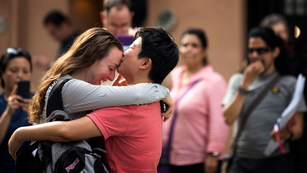 Xingha Shang and Susan Stoever embrace as they join a crowd celebrating the U.S. Supreme Court ruling against the Defense of Marriage Act, in New York