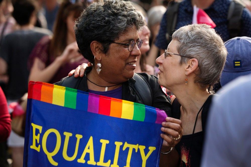 Carmen Castro carries an "Equality" flag as she greets Wind Vogel while celebrating the U.S. Supreme Court ruling against the Defense of Marriage Act outside the Stonewall Inn, June 26, 2013. (Photo by Lucas Jackson/Reuters)