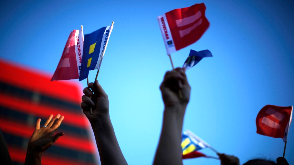 People wave marriage equality flags in West Hollywood, after the United States Supreme Court ruled on California's Proposition 8 and the federal DOMA