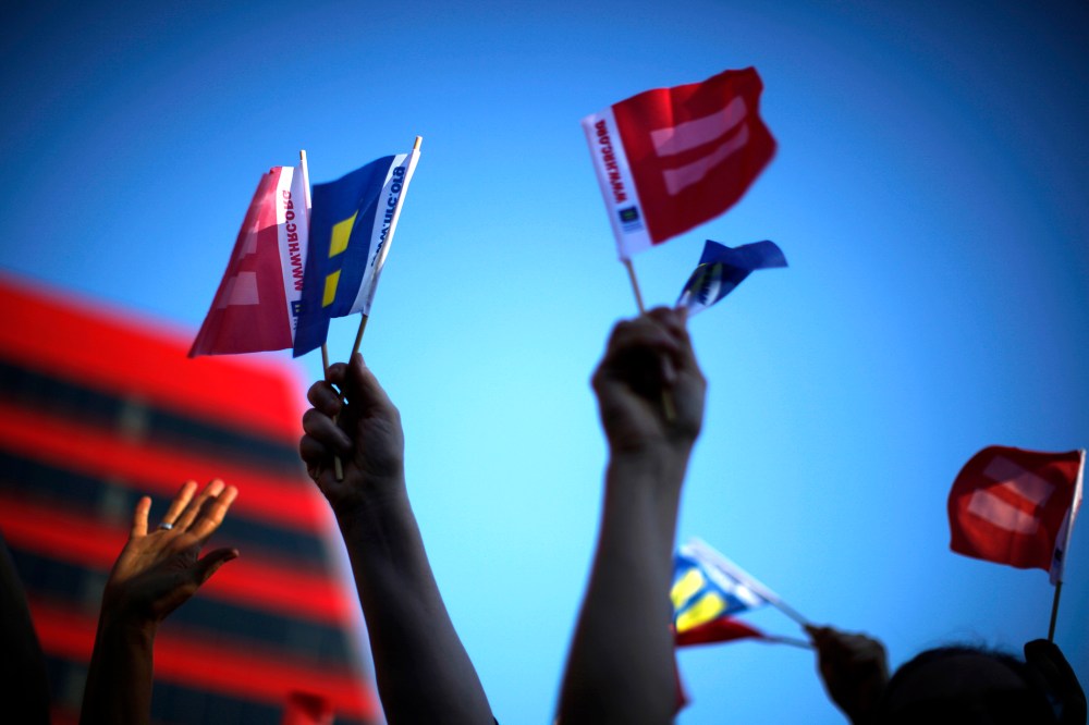 People wave marriage equality flags in West Hollywood, after the United States Supreme Court ruled on California's Proposition 8 and the federal DOMA
