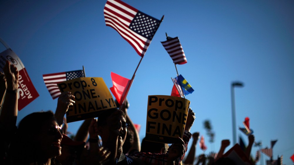 People wave U.S. and marriage equality flags in West Hollywood, Calif. after the United States Supreme Court ruled on California's Proposition 8 and the federal Defense of Marriage Act June 26, 2013.