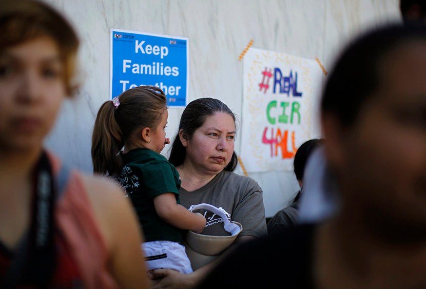 People listen to a broadcast of the debate in Congress at a 24-hour vigil calling on Congress to pass immigration reform in Los Angeles, June 27, 2013.  (Photo by Lucy Nicholson/Reuters)