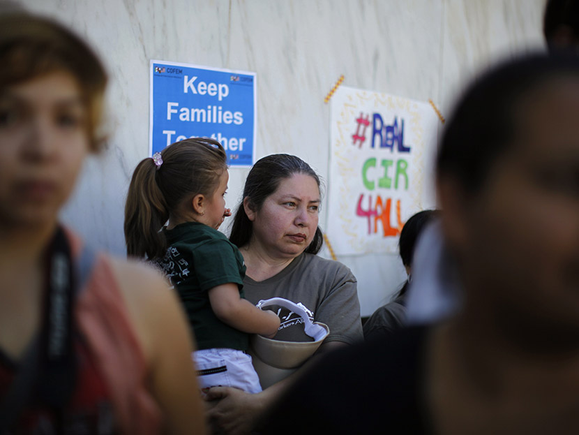 People listen to a broadcast of the debate in Congress at a 24-hour vigil calling on Congress to pass immigration reform in Los Angeles, June 27, 2013. (Photo by Lucy Nicholson/Reuters)