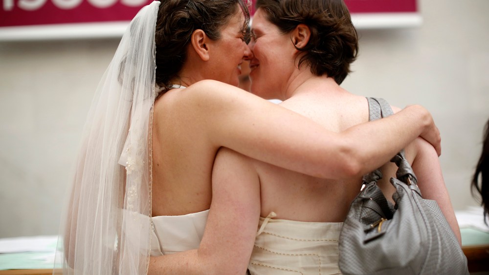 Same-sex couple Cynthia Wides (L) and Elizabeth Carey embrace each other as they turn in their marriage license at City Hall in San Francisco, on June 29, 2013.