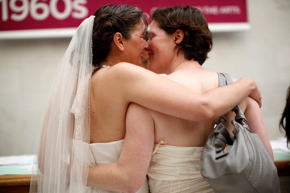 Same-sex couple Cynthia Wides (L) and Elizabeth Carey embrace each other as they turn in their marriage license at City Hall in San Francisco, on June 29, 2013.