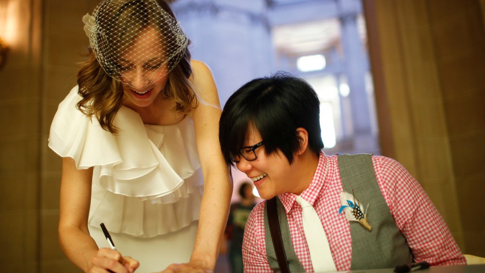 Ashlee Meyer (L) and partner KY Choi (R) sign their marriage license as they prepare to get married, June 29, 2013 at City Hall in San Francisco, Calif.