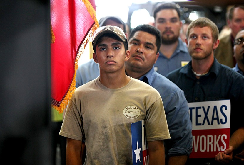 Employees of Holt Cat listen as Texas governor Rick Perry announces he is not running for re-election as governor of Texas in 2014 during a news conference in San Antonio, Texas July 8, 2013.   (Photo by Erich Schlegel/Reuters)