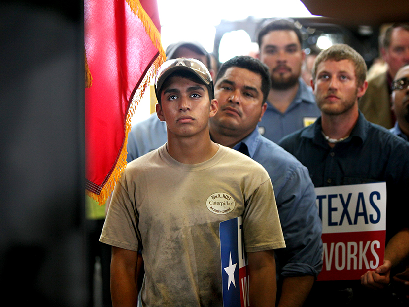 Employees of Holt Cat listen as Texas governor Rick Perry announces he is not running for re-election as governor of Texas in 2014 during a news conference in San Antonio, Texas July 8, 2013.   (Photo by Erich Schlegel/Reuters)