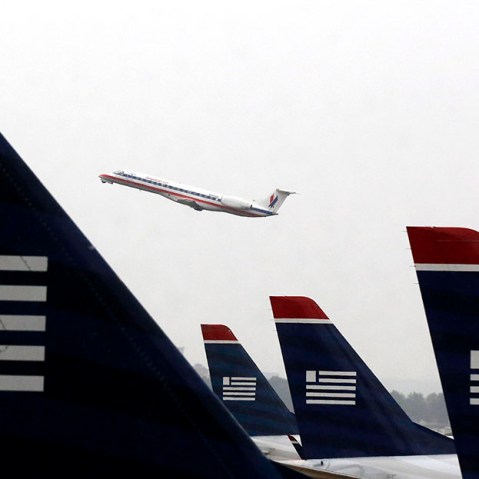 An American Eagle Embraer ERJ-140LR jet takes off as U.S. Airways jets are lined up at Reagan National Airport in Washington July 12, 2013. (Photo by Larry Downing/Reuters)a