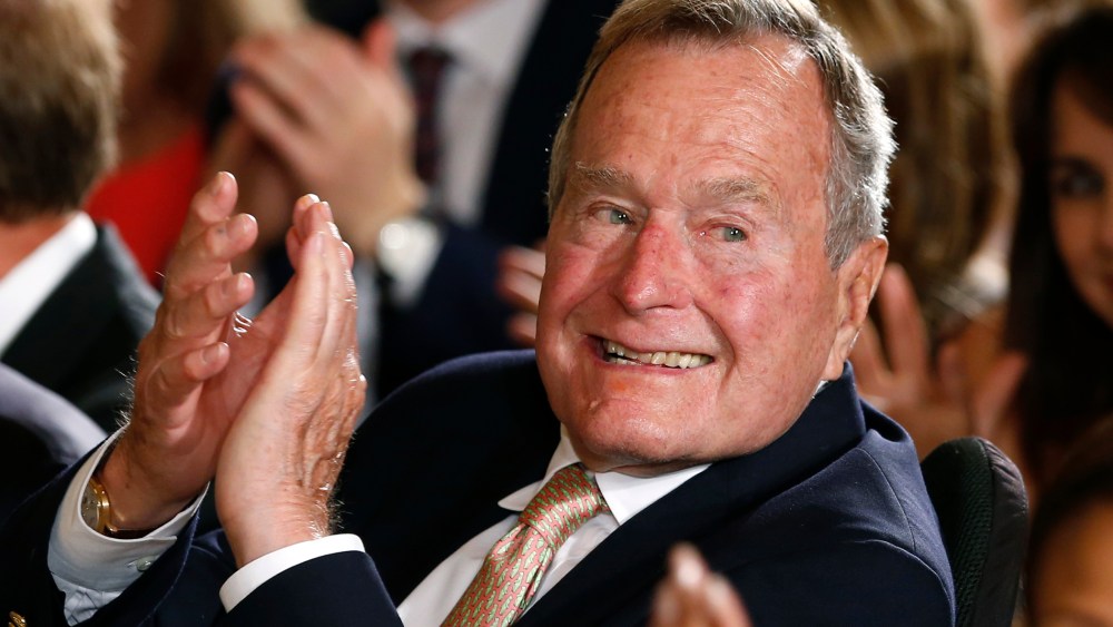 Former President George H. W. Bush applauds during an event at the White House on July 15, 2013.