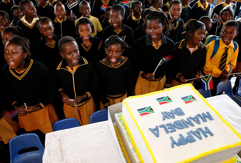 Children sing Happy Birthday to former President Nelson Mandela at a school in Atteridgevile near Pretoria, July 18, 2013. (Photo by Mike Hutchings/Reuters)