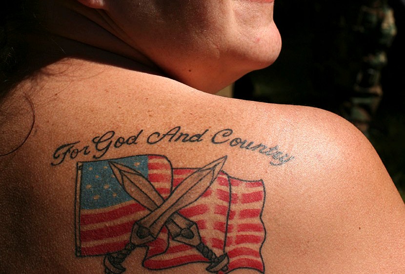 Female soldier from the 63rd battalion from Spokane, Washington, displays her tattoo during the Light Foot Militia annual gathering on Bureau of Land Management land near Priest River, Idaho June 23, 2013.  (Photo by Matt Mills/AP)