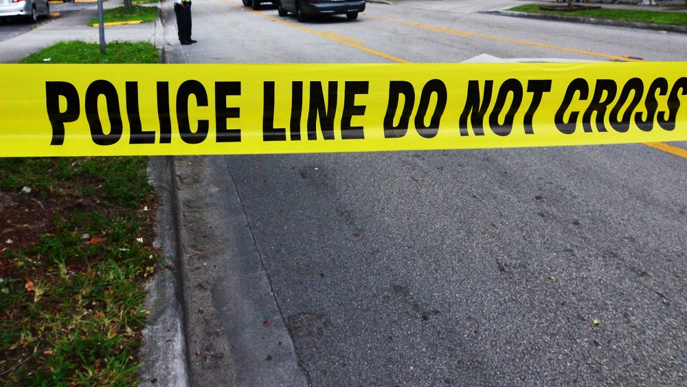Police tape blocks the street to an apartment building. (Gaston De Cardenas/Reuters)