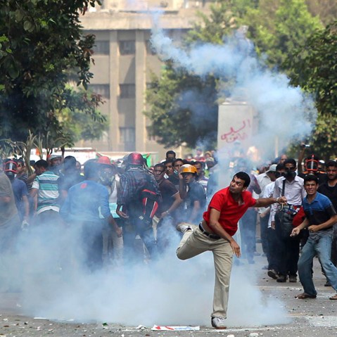 A supporter of ousted President Mohamed Mursi throws a tear gas canister back towards the police during clashes in central Cairo August 13, 2013. (Photo by Asmaa Waguih/Reuters)