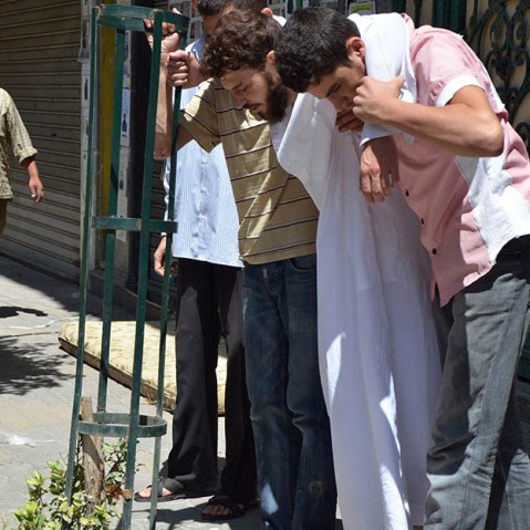 Survivors from what activists say is a gas attack are seen along a street in the Duma neighbourhood of Damascus