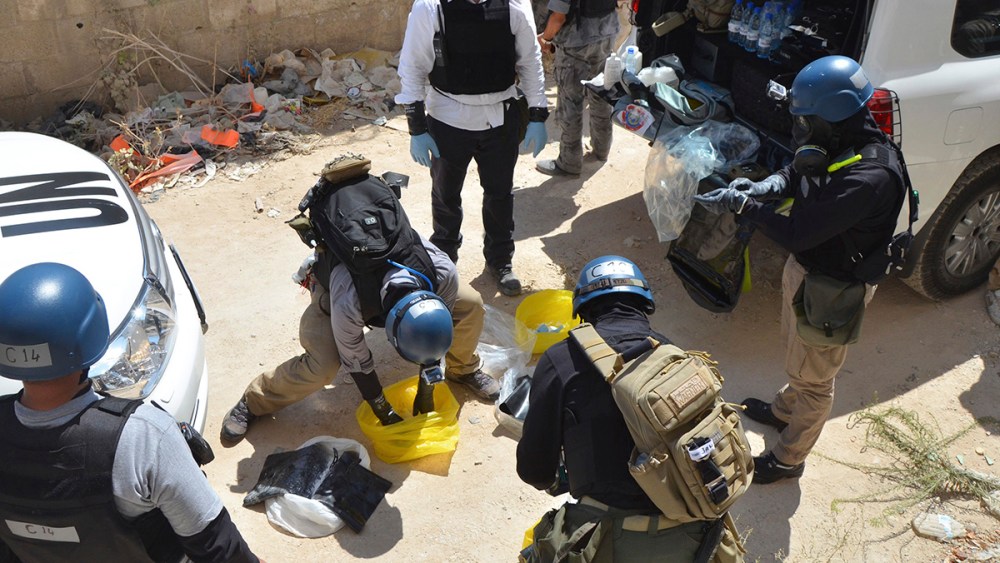 U.N. chemical weapons experts prepare before collecting samples from one of the sites of an alleged chemical weapons attack in Damascus' suburb of Zamalka August 29, 2013.