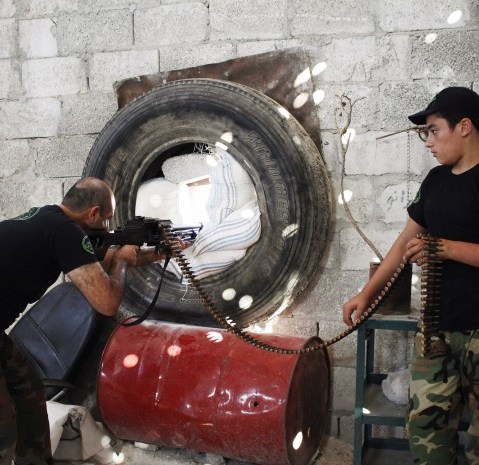 A Free Syrian Army fighter points weapon - Abby Borowitz - 09/3/2013