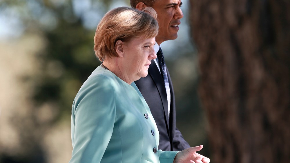 German Chancellor Merkel and U.S. President Obama walk together during the family picture event during the G20 summit in St.Petersburg