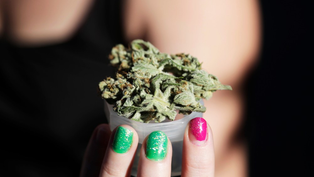 A grower holds out a product at the High Times U.S. Cannabis Cup in Seattle, Washington September 8, 2013.