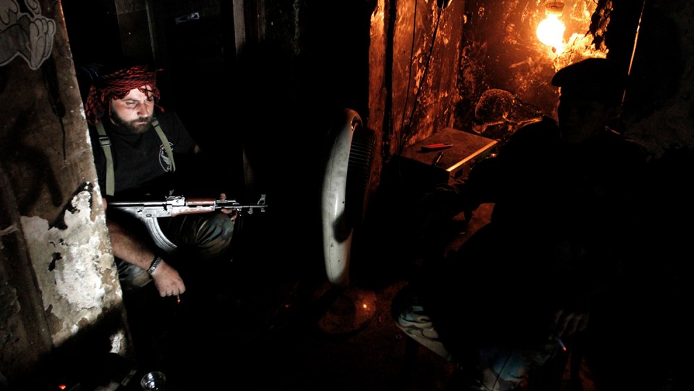 Free Syrian Army fighters smoke cigarettes as they rest in Aleppo's Qastal al-Harami neighbourhood