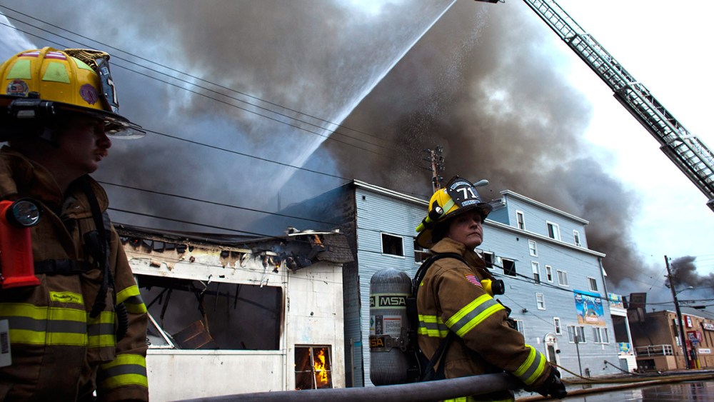 New Jersey firefighters spray water as they try to control a massive fire in Seaside Park in New Jersey