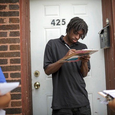 Get Covered America volunteers Cynae Derose (L) and Jalisa Hinkle talk with Daniel Glover about the Affordable Care Act - also known as Obamacare - while canvassing a Chicago, Illinois neighborhood September 7, 2013.