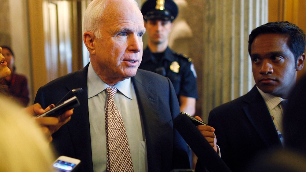 U.S. Senator John McCain talks to reporters as the Senate passes a spending bill to avoid a government shutdown at the U.S. Capitol in Washington on Sept. 27, 2013.