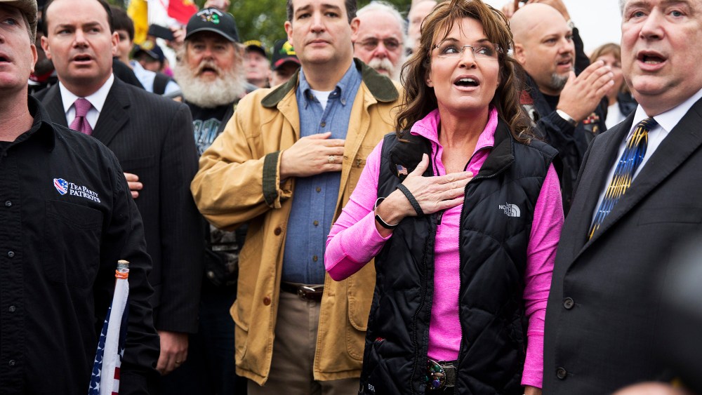 Former Alaska Governor Sarah Palin and Senator Ted Cruz (C) (R-TX) recite the Pledge of Allegiance during the "Million Vet March on the Memorials" at the U.S. National World War II Memorial in Washington on Oct. 13, 2013.