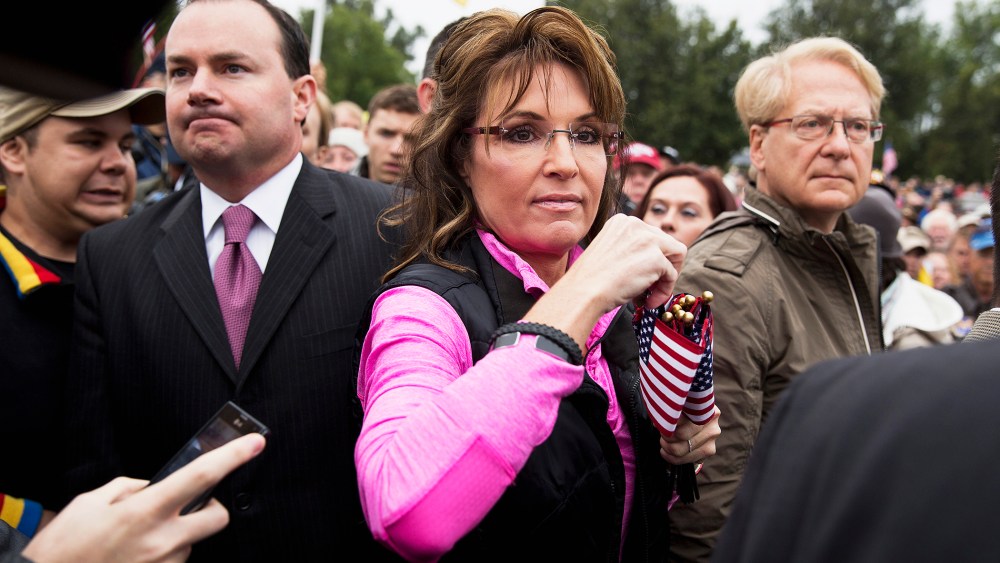 Sarah Palin hands out American Flags to protesters during the "Million Vet March on the Memorials" in Washington, Oct. 13, 2013.
