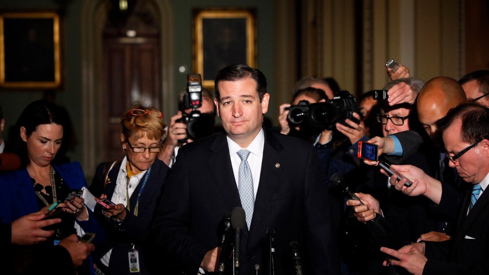 Reporters gather around U.S. Senator Ted Cruz as he talks to reporters after a Republican Senate caucus meeting at the U.S. Capitol in Washington October 16, 2013.