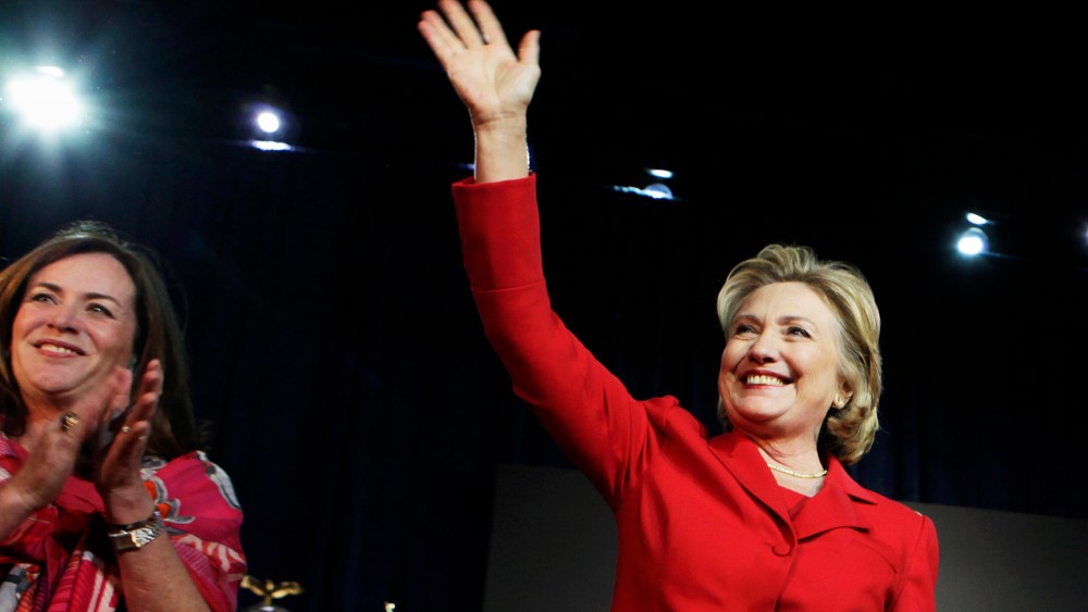 Hillary Clinton waves to the audience at an event to endorse Virginia gubernatorial candidate Terry McAuliffe at The State Theatre in Falls Church, Virginia, October 19, 2013.