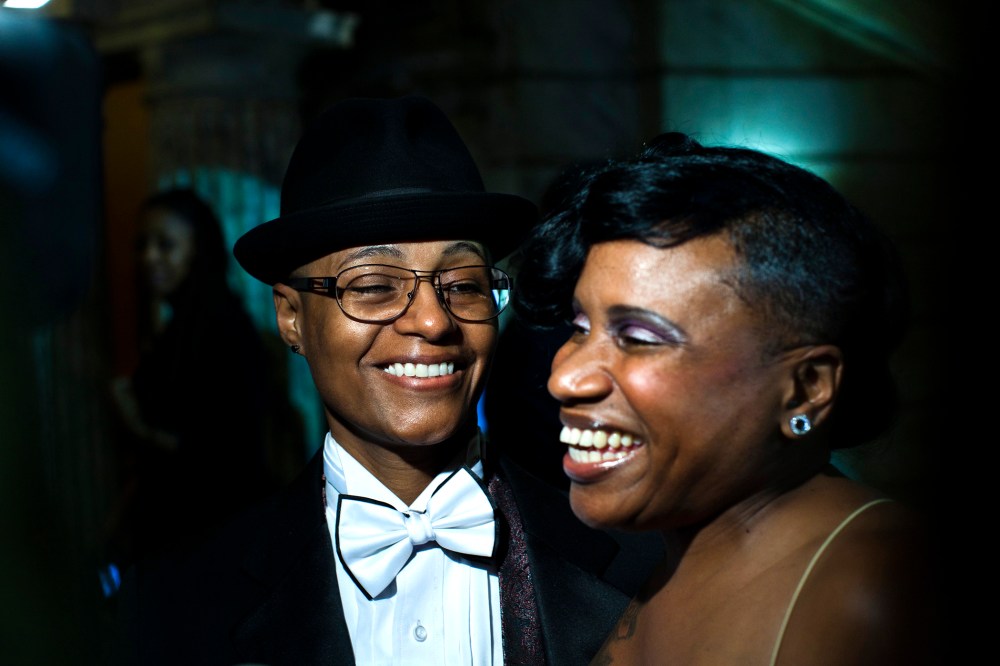 Lydia Torres (L) watches her spouse Jenelle Torres as they talk to the media after their marriage ceremony at City Hall in Newark, New Jersey October 21, 2013.