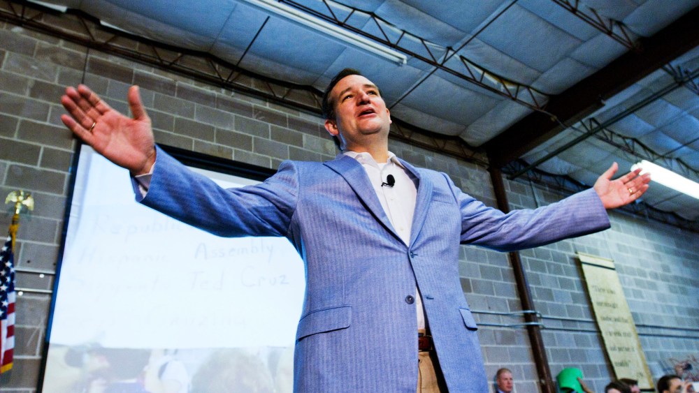 U.S. Senator Ted Cruz gestures on stage as he is welcomed home by supporters in Houston, October 21, 2013.