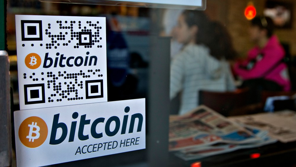 Signs on window advertise a bitcoin ATM machine that has been installed in a Waves Coffee House in Vancouver, British Columbia October 28, 2013.