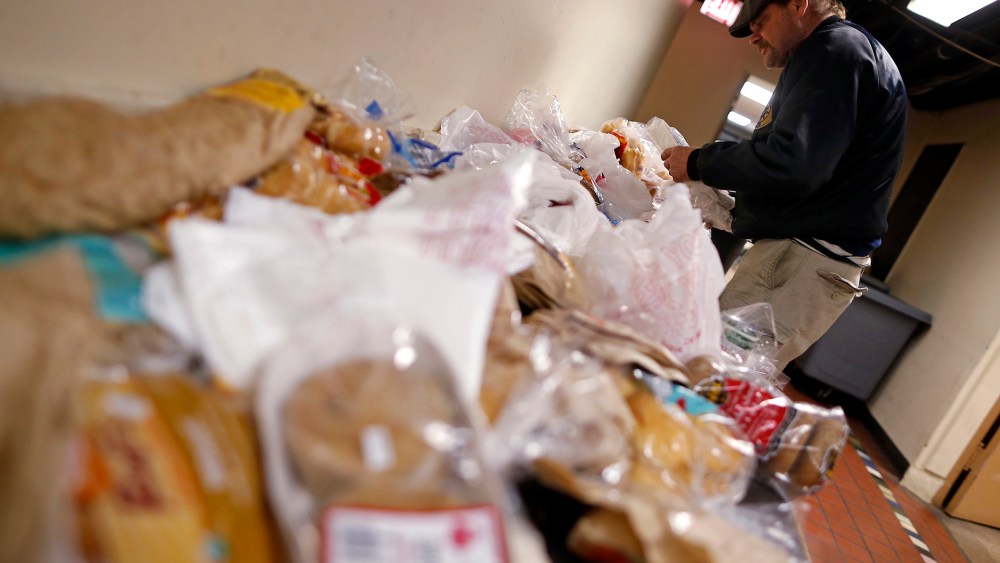 Frank Doyle looks over a table of food at the Emergency Assistance Program at the Chicago Catholic Charities in Chicago